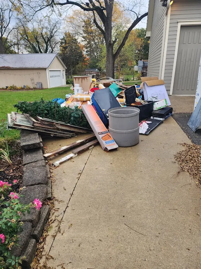 Dumpster being loaded with debris for Estate Cleanout Dumpster Rental in Solon